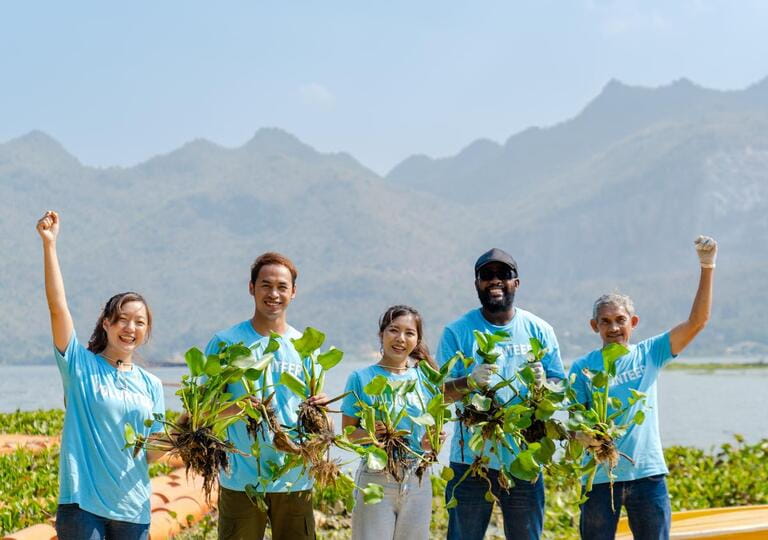 group of cheerful diverse volunteers charitable social working together to collect and remove green water hyacinths from river to protect environment and support the health of local ecosystems group of cheerful diverse volunteers charitable social working together to collect and remove green water hyacinths from river to protect environment and support the health of local ecosystems