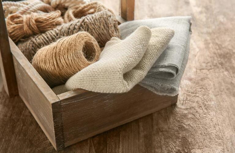 Hemp cloth and rope in a barrel on a wooden background